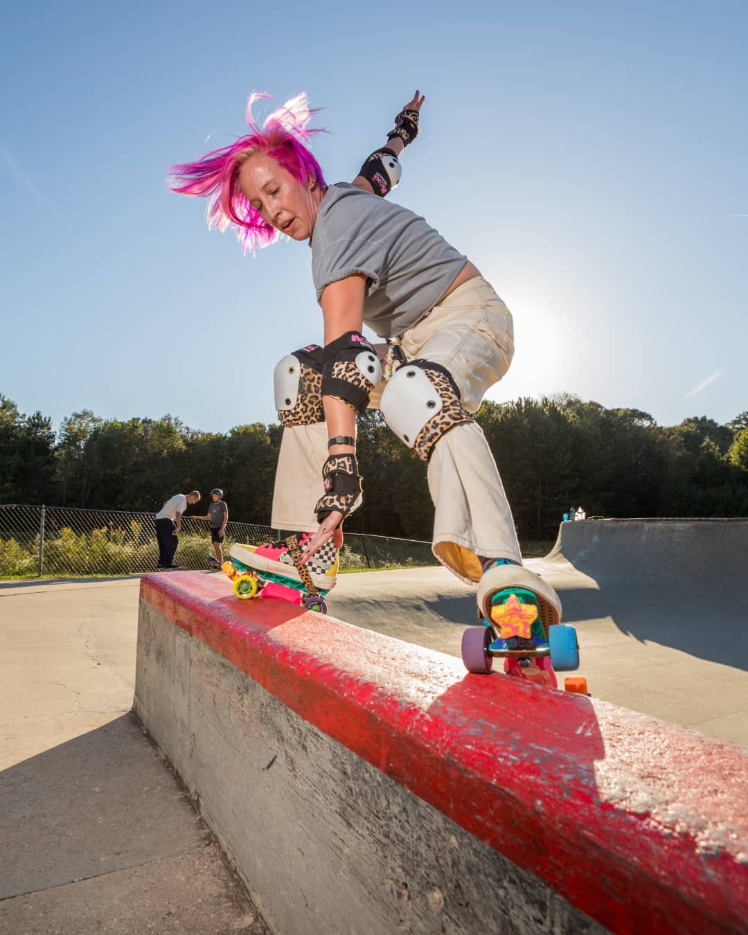female roller skater doing trick with long hair died pink